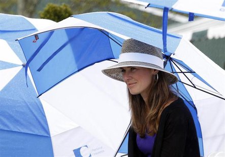 Martina Hingis takes shelter under an umbrella as rain falls during the Tennis Hall of Fame induction ceremony in Newport, Rhode Island July Martina Hingis takes shelter under an umbrella as rain falls during the Tennis Hall of Fame induction ceremony in Newport, Rhode Island July