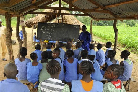 A teacher conducts a lesson under a makeshift classroom at a relief centre for flood victims at St. Boniface primary school in Idah in Niger A teacher conducts a lesson under a makeshift classroom at a relief centre for flood victims at St. Boniface primary school in Idah in Niger