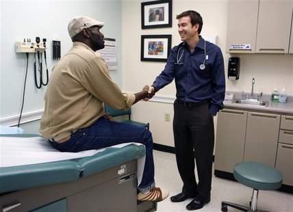 Chief Medical Officer of Whitman-Walker Health Dr. Raymond Martins welcomes patient Eddie Jones, of Washington, in Washington, July 9, 2013. Chief Medical Officer of Whitman-Walker Health Dr. Raymond Martins welcomes patient Eddie Jones, of Washington, in Washington, July 9, 2013.