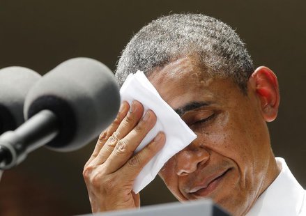 U.S. President Barack Obama pauses and wipes his face as he speaks about his vision to reduce carbon pollution while preparing the country f U.S. President Barack Obama pauses and wipes his face as he speaks about his vision to reduce carbon pollution while preparing the country f