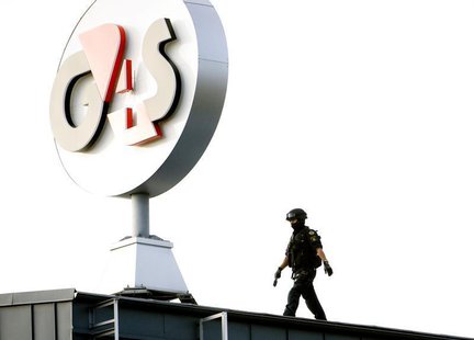 A police Swat team member walks on the roof of G4S cash depot in Vastberga, Stockholm September 23, 2009. REUTERS/Pontus Lundahl/Scanpix A police Swat team member walks on the roof of G4S cash depot in Vastberga, Stockholm September 23, 2009. REUTERS/Pontus Lundahl/Scanpix