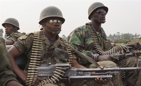 Congolese government army FARDC soldiers ride in their truck towards the frontline where they are fighting against M23 rebels outside the ea Congolese government army FARDC soldiers ride in their truck towards the frontline where they are fighting against M23 rebels outside the ea