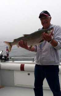 Roy Stromsness of Sioux Falls, S.D. poses with his record-setting whitefish caught off the Sheboygan shore on Thursday. / Submitted photo from the DNR Roy Stromsness of Sioux Falls, S.D. poses with his record-setting whitefish caught off the Sheboygan shore on Thursday. / Submitted photo from the DNR