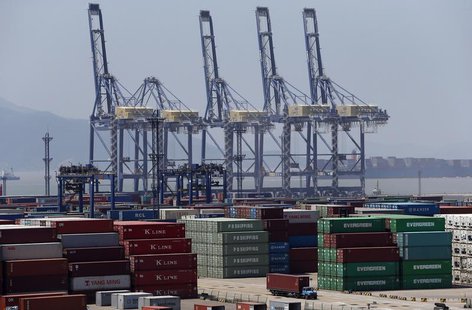 A truck drives past shipping containers at a port in Ningbo, Zhejiang province July 9, 2013. REUTERS/William Hong (CHINA - Tags: BUSINESS) A truck drives past shipping containers at a port in Ningbo, Zhejiang province July 9, 2013. REUTERS/William Hong (CHINA - Tags: BUSINESS)