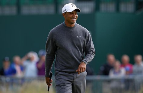 Tiger Woods of the U.S. walks across the 18th green during a practice round ahead of the British Open golf championship at Muirfield in Scot Tiger Woods of the U.S. walks across the 18th green during a practice round ahead of the British Open golf championship at Muirfield in Scot