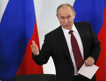 Russian President Vladimir Putin gestures during his visit to the State Military-Historical Museum of Prokhorovka Field July 12, 2013. REUTE Russian President Vladimir Putin gestures during his visit to the State Military-Historical Museum of Prokhorovka Field July 12, 2013. REUTE