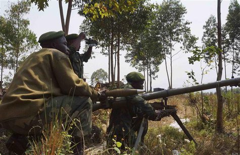 Congolese government army soldiers prepare their weapons at an attack position near Munigi, overlooking the front-line, where they are fight Congolese government army soldiers prepare their weapons at an attack position near Munigi, overlooking the front-line, where they are fight