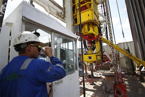 A worker drinks coffee as he watches a drilling process at a shale gas fracking facility run by Poland's PKN Orlen company on the outskirts A worker drinks coffee as he watches a drilling process at a shale gas fracking facility run by Poland's PKN Orlen company on the outskirts