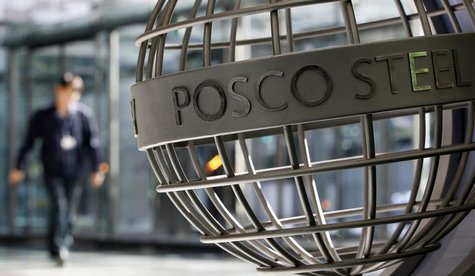 An employee of POSCO walks next to a sculpture with POSCO's logo at the company's headquarters in Seoul October 21, 2011. REUTERS/Jo Yong-Ha An employee of POSCO walks next to a sculpture with POSCO's logo at the company's headquarters in Seoul October 21, 2011. REUTERS/Jo Yong-Ha