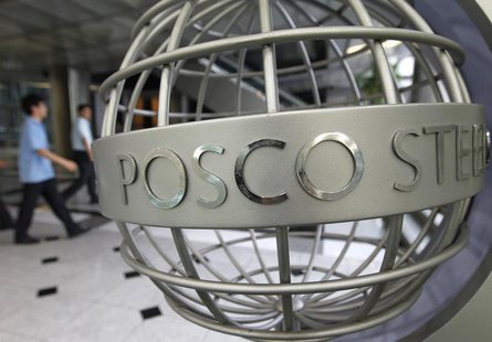 Employees of POSCO walk near a sculpture with POSCO's logo at the company's headquarters in Seoul July 22, 2011. REUTERS/Jo Yong-Hak Employees of POSCO walk near a sculpture with POSCO's logo at the company's headquarters in Seoul July 22, 2011. REUTERS/Jo Yong-Hak