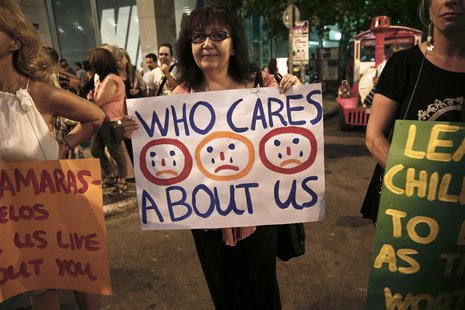 Protesters take part in a demonstration against public sector layoffs, which the government has promised its international lenders in exchan Protesters take part in a demonstration against public sector layoffs, which the government has promised its international lenders in exchan