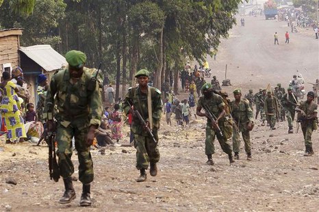 Congolese government army FARDC soldiers walk towards the frontline where they are fighting against M23 rebels outside the eastern Congolese Congolese government army FARDC soldiers walk towards the frontline where they are fighting against M23 rebels outside the eastern Congolese