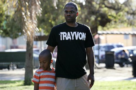 Jovan Blacknell (R) and his son Justice attend a peaceful protest of the acquittal of George Zimmerman for the 2012 shooting death of Trayvo Jovan Blacknell (R) and his son Justice attend a peaceful protest of the acquittal of George Zimmerman for the 2012 shooting death of Trayvo