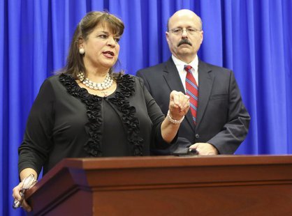 State Attorney Angela Corey and her assistant state attorney Bernie de la Rionda (R) address the media following the not guilty verdict for State Attorney Angela Corey and her assistant state attorney Bernie de la Rionda (R) address the media following the not guilty verdict for