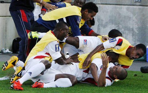 The Cuba team piles onto Jeniel Molina (bottom R) after he scored against Belize during their CONCACAF Gold Cup soccer match in Hartford, Co The Cuba team piles onto Jeniel Molina (bottom R) after he scored against Belize during their CONCACAF Gold Cup soccer match in Hartford, Co