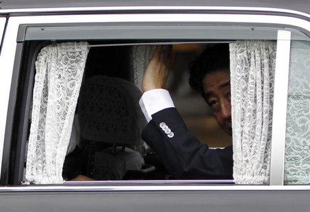 Japan's Prime Minister Shinzo Abe waves to voters from a car during his stumping tour in Tokyo July 4, 2013 file photo. REUTERS/Yuya Shino Japan's Prime Minister Shinzo Abe waves to voters from a car during his stumping tour in Tokyo July 4, 2013 file photo. REUTERS/Yuya Shino