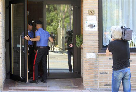 Carabinieri police officers talk at the entrance of the Fra I Pini hotel, where Jamaican sprinters Asafa Powell and Sherone Simpson stayed i Carabinieri police officers talk at the entrance of the Fra I Pini hotel, where Jamaican sprinters Asafa Powell and Sherone Simpson stayed i