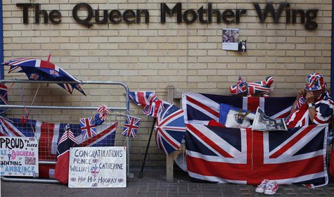 A Royal fan reads the newspaper outside St Mary's Hospital opposite the Lindo Wing, where Britain's Catherine, Duchess of Cambridge is due t A Royal fan reads the newspaper outside St Mary's Hospital opposite the Lindo Wing, where Britain's Catherine, Duchess of Cambridge is due t