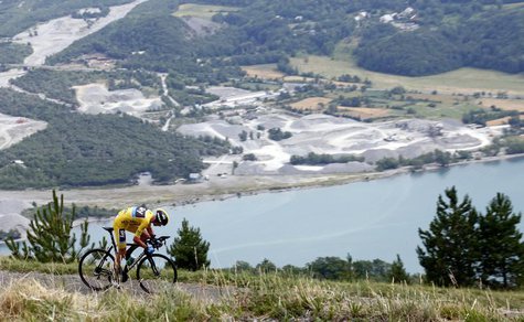 Race leader's yellow jersey holder Team Sky rider Christopher Froome cycles past spectators to win the 32km individual time-trial seventeent Race leader's yellow jersey holder Team Sky rider Christopher Froome cycles past spectators to win the 32km individual time-trial seventeent