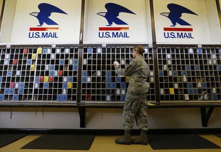 Postal clerk Arin Vickers sorts mail for delivery in the U.S. post office at RAF Alconbury, near Huntingdon, central England June 11, 2013. Postal clerk Arin Vickers sorts mail for delivery in the U.S. post office at RAF Alconbury, near Huntingdon, central England June 11, 2013.