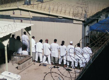 Detainees participate in an early morning prayer session at Camp IV at the detention facility in Guantanamo Bay U.S. Naval Base August 5, 20 Detainees participate in an early morning prayer session at Camp IV at the detention facility in Guantanamo Bay U.S. Naval Base August 5, 20