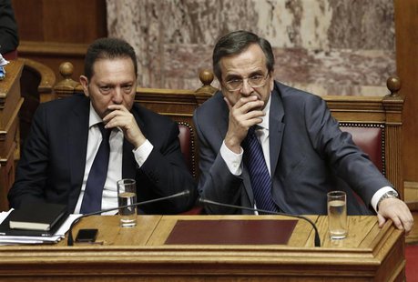 Greece's Prime Minister Antonis Samaras (R) and Finance Minister Yannis Stournaras attend a parliament session during a vote on a series of Greece's Prime Minister Antonis Samaras (R) and Finance Minister Yannis Stournaras attend a parliament session during a vote on a series of
