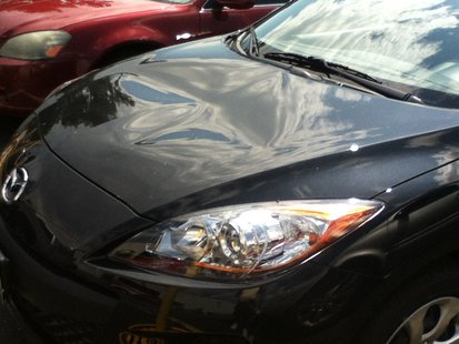 vandals smashed the hood of this Mazda 3 vandals smashed the hood of this Mazda 3