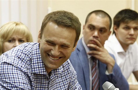 Russian protest leader Alexei Navalny (2nd L) smiles during a court hearing in Kirov, July 18, 2013. REUTERS/Sergei Karpukhin Russian protest leader Alexei Navalny (2nd L) smiles during a court hearing in Kirov, July 18, 2013. REUTERS/Sergei Karpukhin