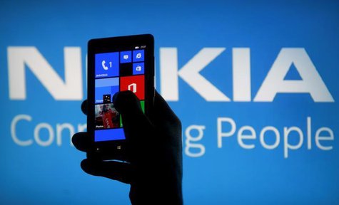 A woman poses with a Nokia Lumia smartphone in this photo illustration in the central Bosnian town of Zenica, May 6, 2013. REUTERS/Dado Ruvi A woman poses with a Nokia Lumia smartphone in this photo illustration in the central Bosnian town of Zenica, May 6, 2013. REUTERS/Dado Ruvi