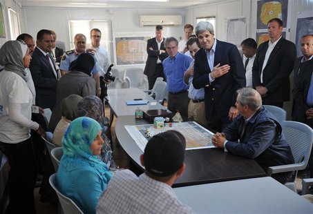 U.S. Secretary of State John Kerry (2nd R) greets a group of Syrian refugees during a joint meeting with Jordanian Foreign Minister Nasser J U.S. Secretary of State John Kerry (2nd R) greets a group of Syrian refugees during a joint meeting with Jordanian Foreign Minister Nasser J