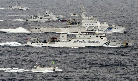 An aerial photo shows a Chinese marine surveillance ship Haijian No. 66 (C) cruising next to Japan Coast Guard patrol ships in the East Chin An aerial photo shows a Chinese marine surveillance ship Haijian No. 66 (C) cruising next to Japan Coast Guard patrol ships in the East Chin