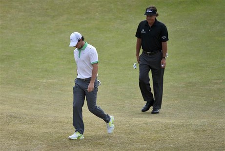 Rory McIlroy of Northern Ireland (L) walks off the fourth green after his bogey putt followed by Phil Mickelson of the U.S. during the first Rory McIlroy of Northern Ireland (L) walks off the fourth green after his bogey putt followed by Phil Mickelson of the U.S. during the first
