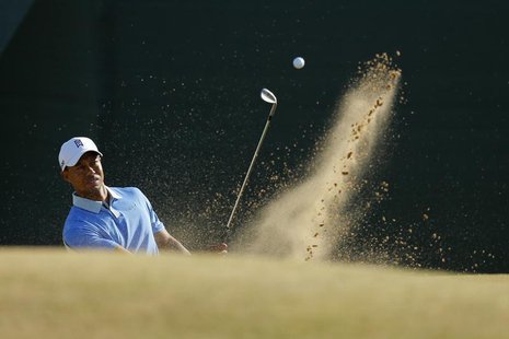 Tiger Woods hits out of a bunker on the 11th hole during a practice round ahead of the British Open golf championship at Muirfield in Scotla Tiger Woods hits out of a bunker on the 11th hole during a practice round ahead of the British Open golf championship at Muirfield in Scotla