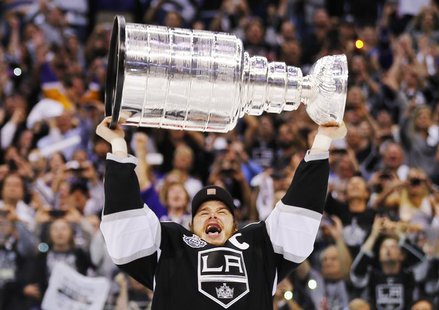 Los Angeles Kings captian Dustin Brown hoists the Stanley Cup after his team defeated the New Jersey Devils during Game 6 of the NHL Stanley Los Angeles Kings captian Dustin Brown hoists the Stanley Cup after his team defeated the New Jersey Devils during Game 6 of the NHL Stanley