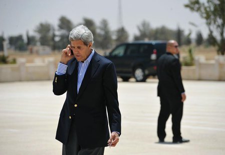 U.S. Secretary of State John Kerry speaks on the phone at Mafraq Air Base before boarding a helicopter to Amman, after visiting Zaatari refu U.S. Secretary of State John Kerry speaks on the phone at Mafraq Air Base before boarding a helicopter to Amman, after visiting Zaatari refu