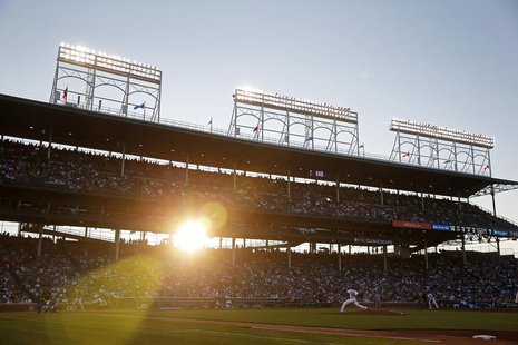 Chicago Cubs' Edwin Jackson (R) pitches against St. Louis Cardinals' Pete Kozma as the sun sets during the third inning of their National Le Chicago Cubs' Edwin Jackson (R) pitches against St. Louis Cardinals' Pete Kozma as the sun sets during the third inning of their National Le