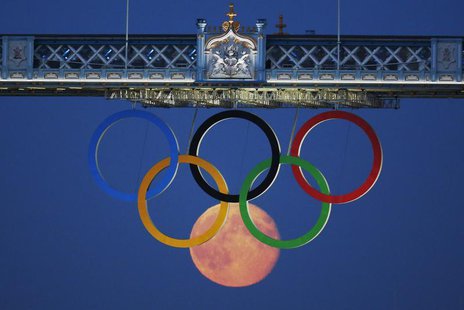 The full moon rises through the Olympic Rings hanging beneath Tower Bridge during the London 2012 Olympic Games August 3, 2012. REUTERS/Luke The full moon rises through the Olympic Rings hanging beneath Tower Bridge during the London 2012 Olympic Games August 3, 2012. REUTERS/Luke