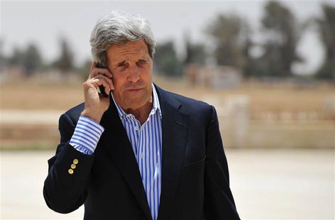 U.S. Secretary of State John Kerry speaks on the phone at Mafraq Air Base before boarding a helicopter to Amman, after visiting Zaatari refu U.S. Secretary of State John Kerry speaks on the phone at Mafraq Air Base before boarding a helicopter to Amman, after visiting Zaatari refu
