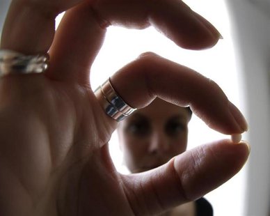 An illustration picture shows a woman holding a birth control pill at her home in Nice January 3, 2013. REUTERS/Eric Gaillard An illustration picture shows a woman holding a birth control pill at her home in Nice January 3, 2013. REUTERS/Eric Gaillard