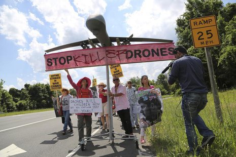 Protesters against drone strikes walk along the highway with a model of a drone in an attempt to deliver a letter to U.S. Central Intelligen Protesters against drone strikes walk along the highway with a model of a drone in an attempt to deliver a letter to U.S. Central Intelligen