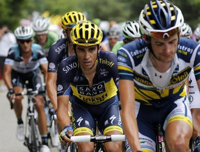 Team Saxo-Tinkoff rider Alberto Contador (C) of Spain climbs the Alpe d'Huez mountain during the 172.5km eighteenth stage of the centenary T Team Saxo-Tinkoff rider Alberto Contador (C) of Spain climbs the Alpe d'Huez mountain during the 172.5km eighteenth stage of the centenary T