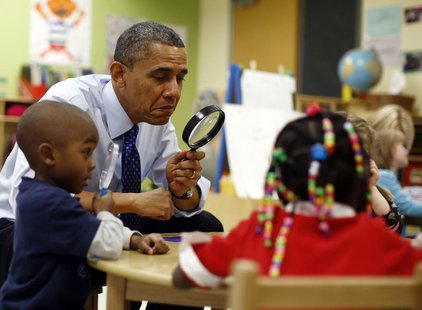 U.S. President Barack Obama uses a magnifying glass to play a game with children in a pre-kindergarten classroom at College Heights early ch U.S. President Barack Obama uses a magnifying glass to play a game with children in a pre-kindergarten classroom at College Heights early ch
