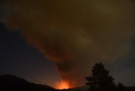 A plume of smoke rises into the night sky as a wildfire, or the so-called Mountain Fire, burns near Idyllwild, California July 18, 2013. REU A plume of smoke rises into the night sky as a wildfire, or the so-called Mountain Fire, burns near Idyllwild, California July 18, 2013. REU