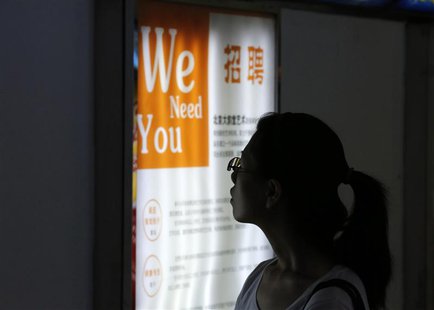A job seeker looks at a job advertisement board at a Beijing talent service centre July 17, 2013. Picture taken July 17, 2013. REUTERS/Kim K A job seeker looks at a job advertisement board at a Beijing talent service centre July 17, 2013. Picture taken July 17, 2013. REUTERS/Kim K