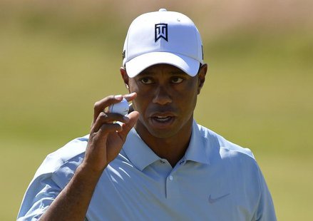 Tiger Woods of the U.S. acknowledges the crowd after his par putt on the tenth green during the second round of the British Open golf Champi Tiger Woods of the U.S. acknowledges the crowd after his par putt on the tenth green during the second round of the British Open golf Champi