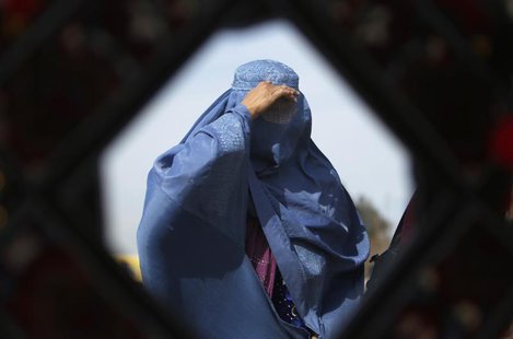 An Afghan woman is reflected in a mirror as she walks in Kabul February 11, 2013. REUTERS/Mohammad Ismail An Afghan woman is reflected in a mirror as she walks in Kabul February 11, 2013. REUTERS/Mohammad Ismail