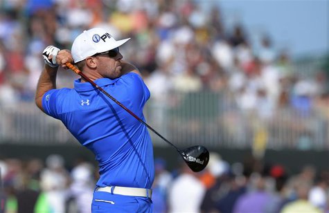 Hunter Mahan of the U.S. watches his tee shot on the 18th green during the third round of the British Open golf Championship at Muirfield in Hunter Mahan of the U.S. watches his tee shot on the 18th green during the third round of the British Open golf Championship at Muirfield in