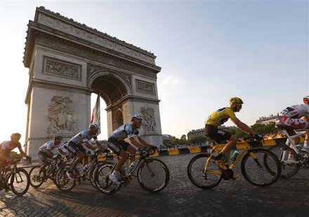 The pack of riders including Team Sky rider and leader's yellow jersey holder Christopher Froome of Britain cycles past the Arc de Triomphe The pack of riders including Team Sky rider and leader's yellow jersey holder Christopher Froome of Britain cycles past the Arc de Triomphe