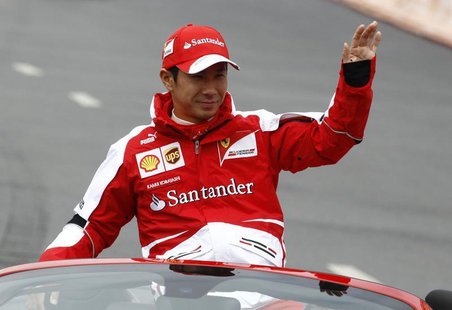 Ferrari Formula One test pilot Kamui Kobayashi waves to spectators during the Moscow City Racing event in Moscow July 21, 2013. REUTERS/Serg Ferrari Formula One test pilot Kamui Kobayashi waves to spectators during the Moscow City Racing event in Moscow July 21, 2013. REUTERS/Serg