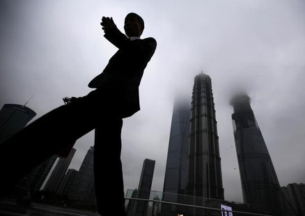 A businessman looks at his mobile phone as he walks in the financial area of Pudong in Shanghai May 30, 2013. REUTERS/Carlos Barria A businessman looks at his mobile phone as he walks in the financial area of Pudong in Shanghai May 30, 2013. REUTERS/Carlos Barria